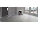 Bright living room with a modern fireplace and large windows offering plenty of natural light at 4952 Cinnabar Trl, Brownsburg, IN 46112