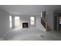 Spacious living room with a fireplace and large windows, offering abundant natural light and a cozy ambiance at 4960 Cinnabar Trl, Brownsburg, IN 46112
