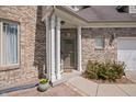 Close-up of the brick front door and covered porch with white columns at 5312 Ripplingbrook Way, Carmel, IN 46033