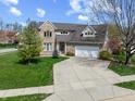 Charming two-story brick home with a well-maintained lawn and attached two-car garage at 5312 Ripplingbrook Way, Carmel, IN 46033