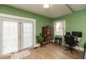 Bright room featuring french doors, a decorative cabinet, and hardwood floors at 5973 Masten Rd, Coatesville, IN 46121