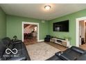 Inviting living room with a large sofa, decorative rug, and a television at 5973 Masten Rd, Coatesville, IN 46121
