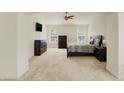 Spacious main bedroom features a ceiling fan, two windows, and dark wood furnishings at 6869 W Winding, McCordsville, IN 46055