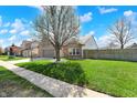 Beautiful brick home showcasing a lovely front yard with blossoming tree at 701 Downing Dr, Greenwood, IN 46143