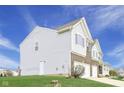 Rear exterior showcasing the home's siding, garage access, and spacious yard at 7048 Millet Ln, Avon, IN 46123