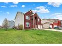 Spacious brick home with two-car garage, well-manicured lawn, and an arched entryway at 7736 Eagle Point Cir, Zionsville, IN 46077