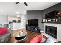 Inviting living room featuring a cozy fireplace and a TV, open to the kitchen at 8810 Yardley Ct # 208, Indianapolis, IN 46268