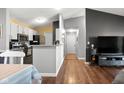 Open concept living room with hardwood floors flows into a well-equipped kitchen at 8810 Yardley Ct # 208, Indianapolis, IN 46268