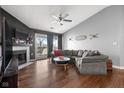 Cozy living room featuring a fireplace, vaulted ceiling, and a sliding glass door to a deck at 8810 Yardley Ct # 208, Indianapolis, IN 46268