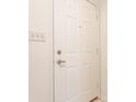 A close-up showcasing a six panel white door with a silver handle and switch plate at 9223 Steeplechase Dr, Indianapolis, IN 46250