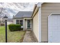 Well-maintained home showcasing an attached single car garage and neat front lawn at 9223 Steeplechase Dr, Indianapolis, IN 46250