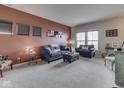 Comfortable living room with stylish gray furniture, neutral carpet, and warm accent wall at 1232 Blue Haven Way, Greenwood, IN 46143