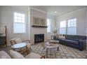 Comfortable living room showcasing a decorative fireplace, large windows, and stylish furniture at 13107 Pennington Rd, Fishers, IN 46037