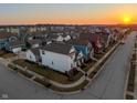Aerial view of a picturesque neighborhood displaying a variety of homes and tranquil surroundings at sunset at 1401 Farmhouse Dr, Westfield, IN 46074