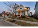 Charming two-story home with a welcoming front porch, manicured lawn, and inviting curb appeal at 1401 Farmhouse Dr, Westfield, IN 46074