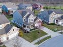 Charming two-story home with landscaped front yard, covered porch, and a neighborhood of similar homes at 14059 Knightstown E Dr, Carmel, IN 46033