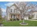 Attractive two-story home with a well-maintained lawn, covered porch, and tree in the front yard at 1458 Longleaf St, Avon, IN 46123