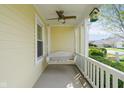 Cozy front porch with a hanging swing and a decorative birdhouse for relaxation at 1920 Mystic Bay Ct, Indianapolis, IN 46240