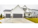 Beautiful two-story home boasts modern farmhouse style with a three-car garage and lawn at 19983 Chatham Green Dr, Westfield, IN 46074
