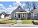 Charming home featuring a covered front porch, gray siding, and a well-manicured lawn, creating a welcoming curb appeal at 2041 N Dexter St, Indianapolis, IN 46202