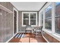 Cozy sunroom featuring natural light, wood-look walls, and a seating area at 211 N Merrill St, Fortville, IN 46040