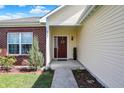 Welcoming front porch featuring a colorful wreath, 'home' doormat, and brick and vinyl siding at 2307 Cedarmill Dr, Franklin, IN 46131
