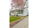 Quaint home featuring a blooming tree, tidy lawn, and a classic brick-lined driveway at 2317 St Peter St, Indianapolis, IN 46203