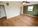 Spacious living room with wood flooring, neutral walls, and ceiling fan fixture at 2317 St Peter St, Indianapolis, IN 46203