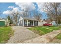 Charming home with gray siding, covered porch, and a gravel driveway at 2336 St Paul St, Indianapolis, IN 46203