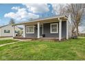 View of a charming gray home with a welcoming covered front porch at 2336 St Paul St, Indianapolis, IN 46203