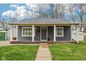 Charming home featuring a covered front porch with white columns and a gray exterior at 2336 St Paul St, Indianapolis, IN 46203
