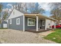 Charming home with covered porch and a gravel driveway at 2336 St Paul St, Indianapolis, IN 46203
