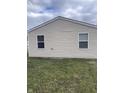 Side view of the home with neutral siding and windows at 2968 N Gale St, Indianapolis, IN 46218