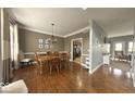 Inviting dining room with hardwood floors and a large wooden table at 3806 Sycamore Bend S Way, Columbus, IN 47203