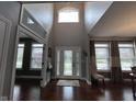 Bright foyer with soaring ceilings, stained-glass front door, and hardwood floors at 3806 Sycamore Bend S Way, Columbus, IN 47203