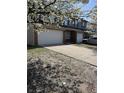 A two-story home features a two-car garage and a concrete driveway with tree at 4217 Carson Ln, Indianapolis, IN 46227