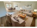 Bright living room featuring stylish neutral-toned furnishings and an adjacent dining area at 439 Pleasantview Dr, Greenwood, IN 46142