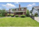 Classic two-story brick home featuring a well-manicured lawn and traditional architectural design at 4720 Central Ave, Indianapolis, IN 46205