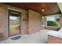 Inviting covered front porch with brick accents and a secure glass front door at 4720 Central Ave, Indianapolis, IN 46205
