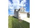 Two-story home with neutral siding, a spacious two-car garage, and a well-kept lawn at 5115 Triple Crown Way, Indianapolis, IN 46237
