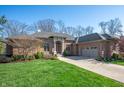 Attractive brick home with a well-kept lawn and inviting curb appeal at 5202 Logan Ln, Indianapolis, IN 46250