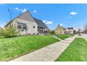 Beautiful house featuring stone accents, a manicured lawn, and a sidewalk at 524 N Meridian St, Lebanon, IN 46052