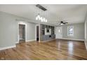 Bright living room features hardwood floors, neutral walls, and built-in shelving with stylish lighting at 5442 W 400 N, Fairland, IN 46126
