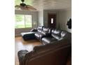 Cozy living room featuring hardwood floors, a ceiling fan and large sectional sofa at 6426 Maple Lawn Rd, Indianapolis, IN 46241