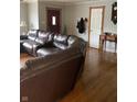 Comfortable living room boasting hardwood floors, and a large sectional sofa at 6426 Maple Lawn Rd, Indianapolis, IN 46241