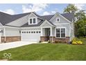 Charming home with a two-car garage and well-manicured lawn at 745 Stone Trace Ct, Avon, IN 46123