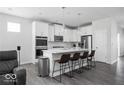 Modern kitchen featuring white cabinets, stainless steel appliances, and island seating at 745 Stone Trace Ct, Avon, IN 46123