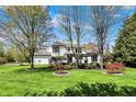 Spacious backyard with mature trees, lush lawn and meticulous landscaping at 7531 Normandy Blvd, Indianapolis, IN 46278