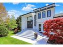 Contemporary home featuring a striking entrance with bold windows and well-maintained landscaping at 7531 Normandy Blvd, Indianapolis, IN 46278