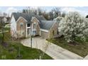 Beautiful two-story brick home with attached garage, basketball hoop, and flowering trees accenting the well-manicured front lawn at 805 Harvest Lake Dr, Brownsburg, IN 46112